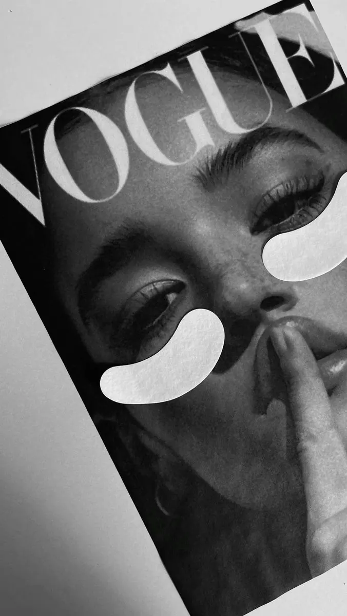 Vogue magazine cover with under-eye masks — editorial flat lay